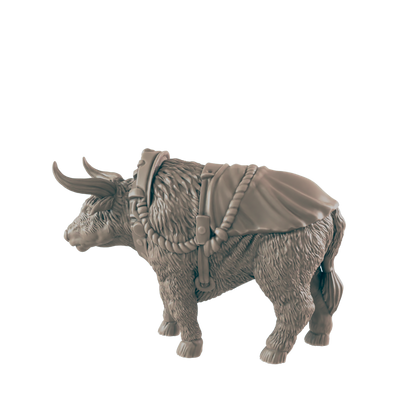 A hairy yak stands, wearing a saddle and harness, against a plain background.