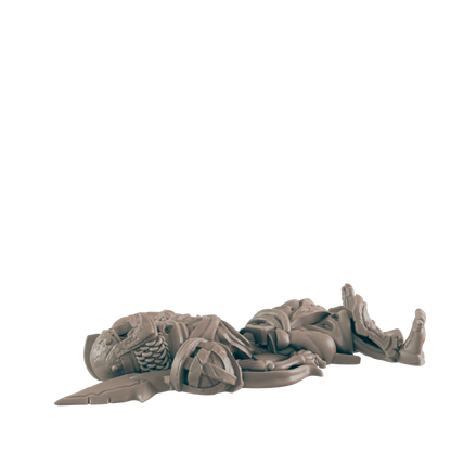 A miniature figure lies broken on a dark background.  It appears to be a warrior, possibly from a game, in a defeated pose.