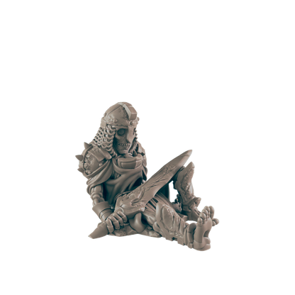 A skeletal warrior miniature sits slumped, holding a large sword, against a black background.