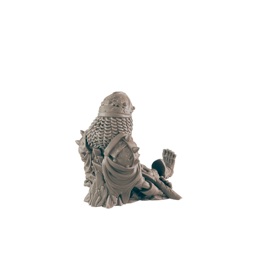 A miniature figurine, depicting a seated armored figure, rests on a plain background.