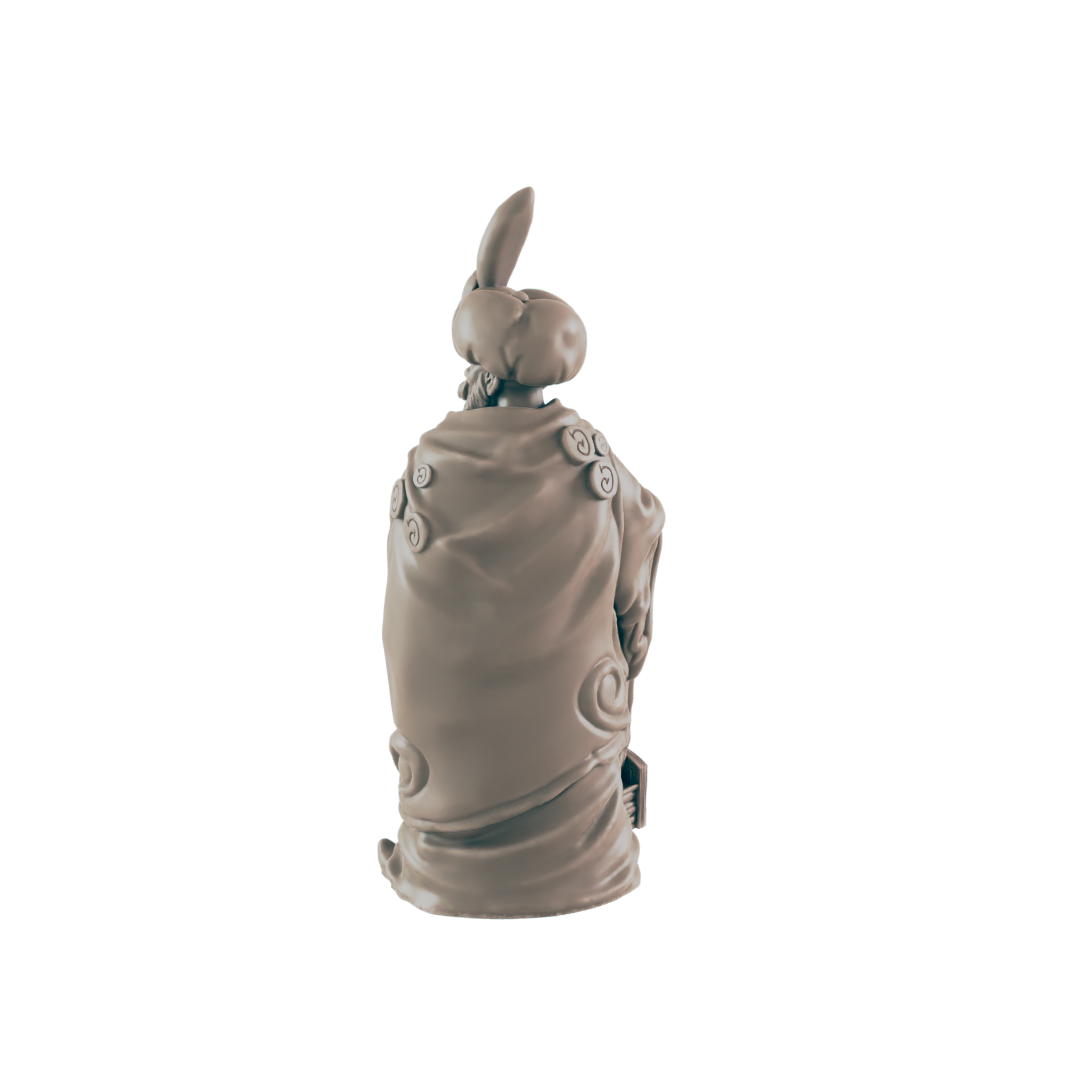 A tan figurine, seemingly a person in a robe and hat, sits against a dark background.