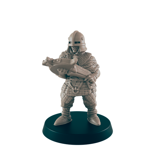 A miniature warrior wearing chainmail and a helmet holds a crossbow, standing firmly on a circular black base, all against a solid black background.