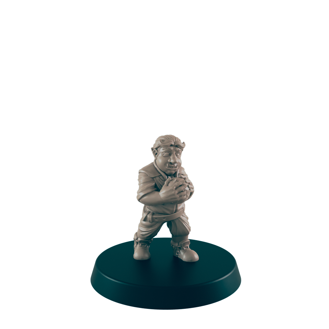 A tan figurine of a stout, possibly orcish, character clutches a sphere; it stands on a dark circular base against a dark background.