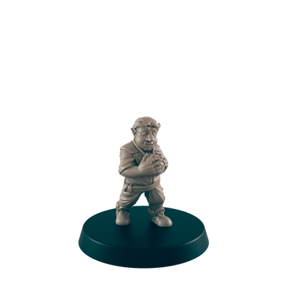 A tan figurine of a stout, possibly orcish, character clutches a sphere; it stands on a dark circular base against a dark background.