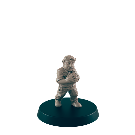 A tan figurine of a stout, possibly orcish, character clutches a sphere; it stands on a dark circular base against a dark background.