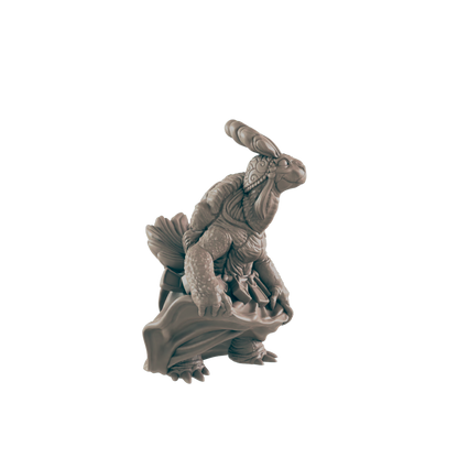 A turtle-like creature, holding a cloth, stands against a dark background.