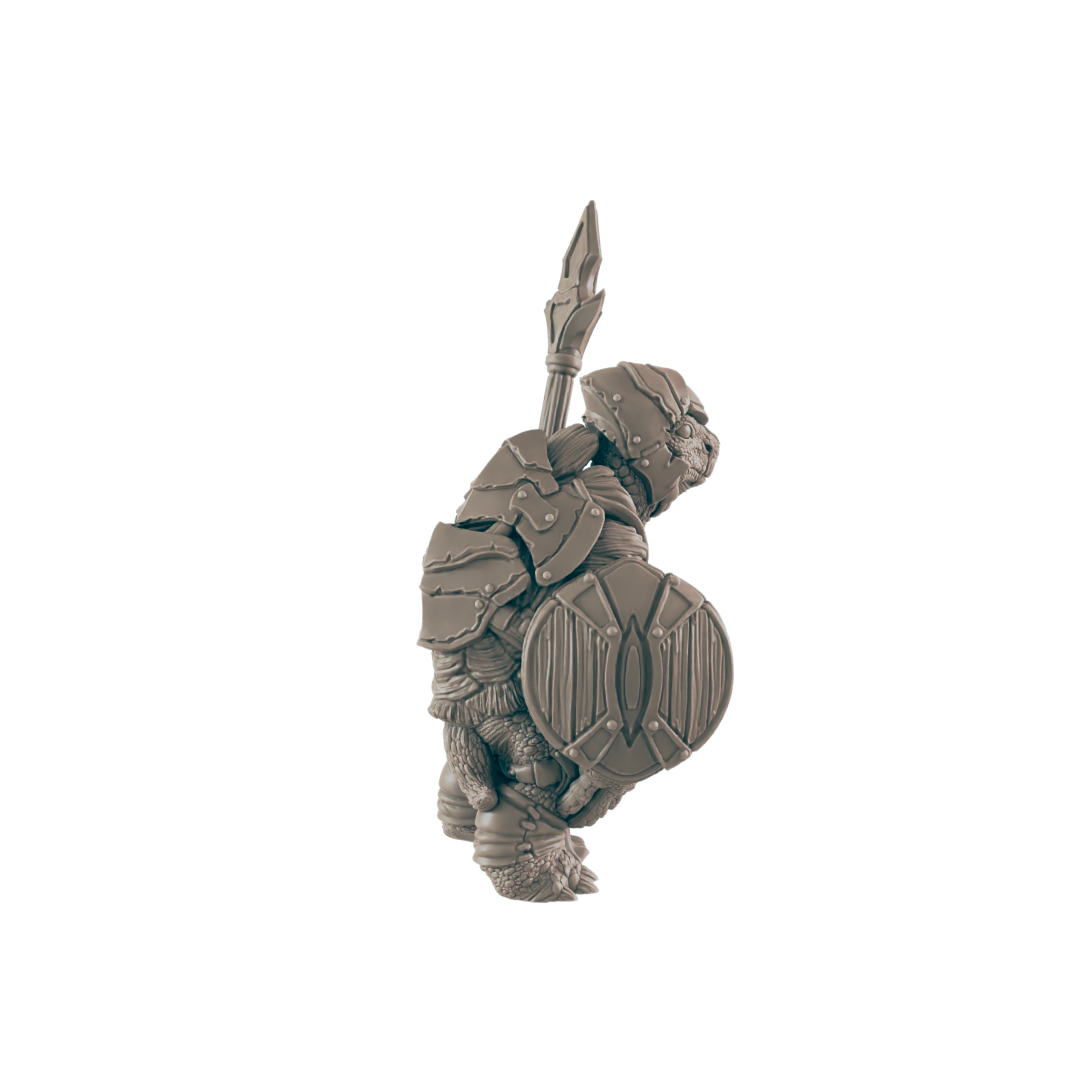A miniature armored turtle warrior stands, holding a spear and shield; against a dark background.