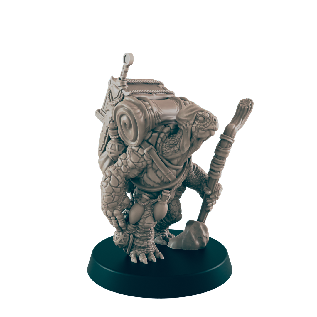 A turtle-like miniature figure carries a backpack and staff, standing on a dark circular base.