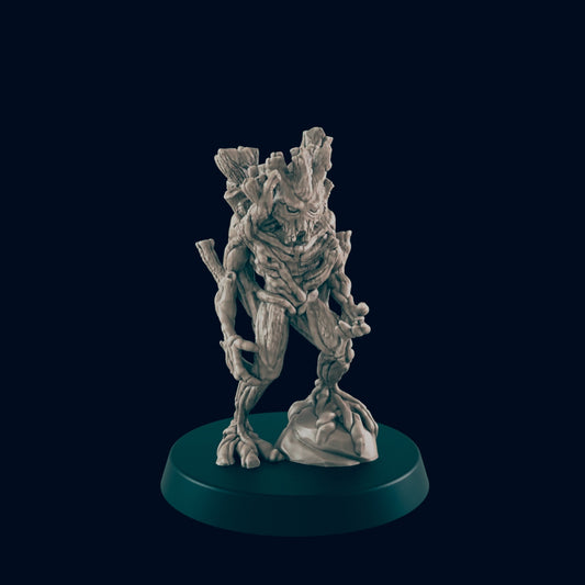 The figure of a humanoid tree-like creature stands on a rocky mound atop a dark green circular base, set against a dark blue background.